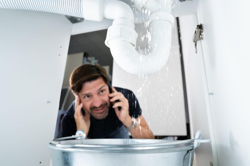 a man contacting a plumber in Edinburgh